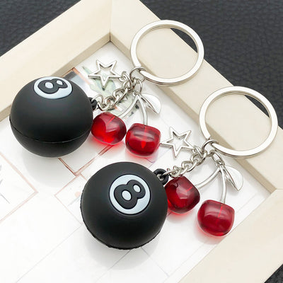 Overview showing the available color and design variations of the black eight ball star and cherry metal keychain