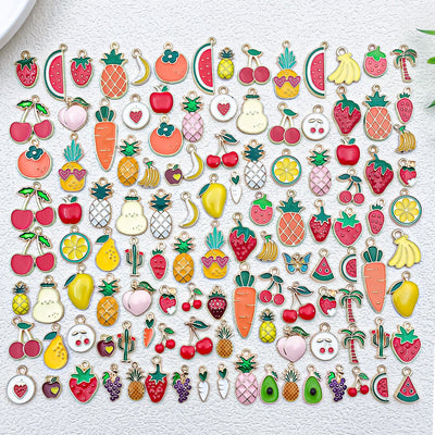 Colorful cherry and strawberry charms arranged on a light background