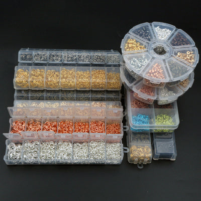 Boxed assortment of jewelry-making rings, clasps, hooks, backs, or tools in a group view on a white background