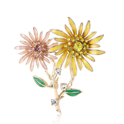 Front view of two enamel daisies in pink and yellow on green stems