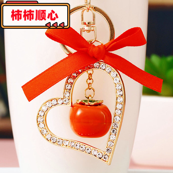 Jeweled Heart Frame Persimmon Keychain with Red Bow and Gold Tone Hardware