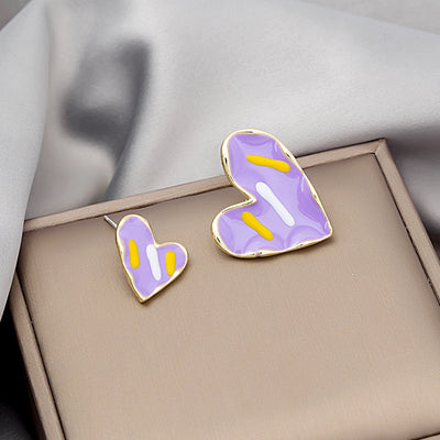Purple large and small enamel heart studs with yellow white dashes on beige box