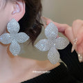 Silver Tone Textured Four Petal Flower Stud Earrings view 1