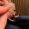Red Enamel and Crystal Gold Tone Hoop Earrings With Metal Details view 4