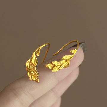 Gold Tone Curved Leaf Hook Earrings With Decorative Metal Details