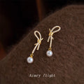 Gold Tone Clear Stone Bow Long Tail And White Pearl Stud Earrings view 4