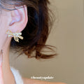 Gold Tone Crystal Bow Tassel Stud Earrings With Polished Metal Details view 4