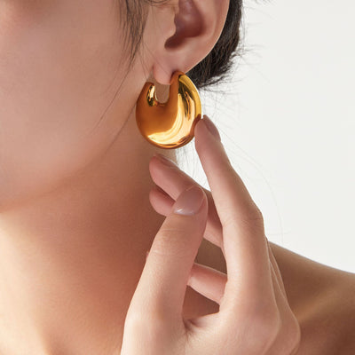 Model wearing gold chunky C-shape polished stud earring