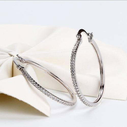 White metal large hoops on cream fabric showing latch backs