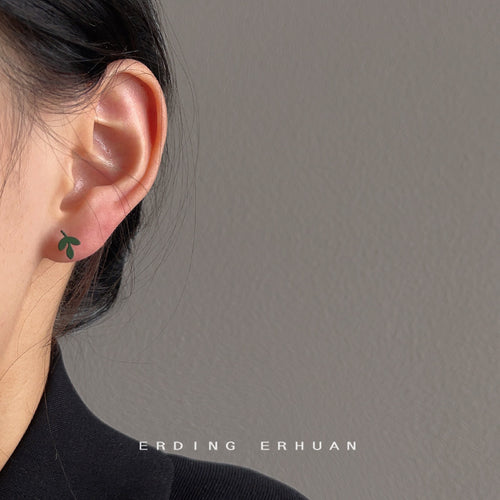 Matte green leaf sprout stud worn on ear side profile