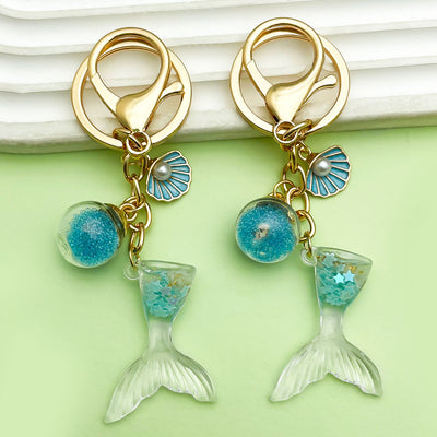 Image 1 showing starfish, conch and shell keychains shown in the product image.