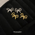 Minimal Bow Stud Earrings in Gold Tone or Silver Tone view 2