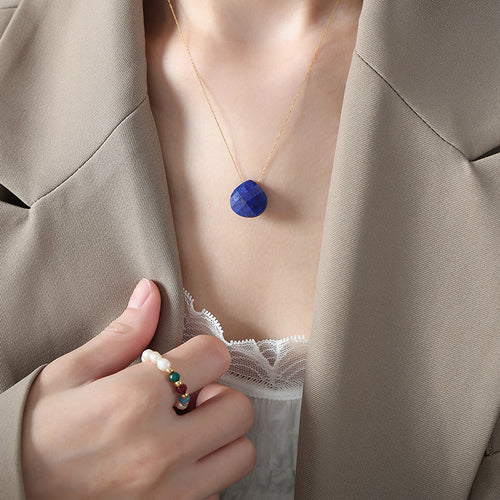 Deep blue faceted teardrop pendant necklace worn