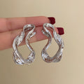 Chunky Twisted Open Hoop Earrings in Gold and Silver Tone view 6