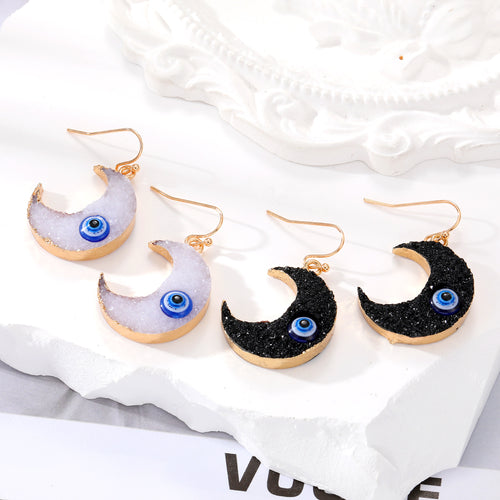 White and black crescent moon evil eye resin drop earrings four pieces on stone