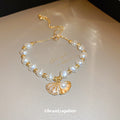 Gold Tone Irregular Pearl Like Slider Bracelet With Shell Charm view 3