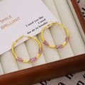 Gold Twisted Hoop Earrings Purple Rhinestone Clusters view 3