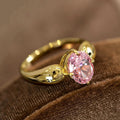 Pink Oval Solitaire Leaf-Shoulder Ring In Polished Gold Tone view 1