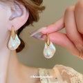 Gold Tone Organic Pearl Drop Earrings With Sculpted Top Detail view 2
