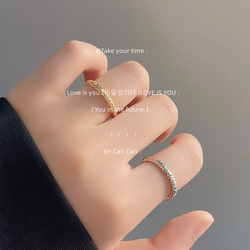 Gold and mixed-tone hammered open rings worn on two fingers