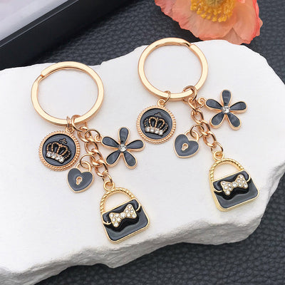 Overview showing the available color and design variations of the fashion handbag lipstick and crown metal keychain
