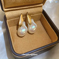 Gold Tone Organic Pearl Drop Earrings With Sculpted Top Detail view 1