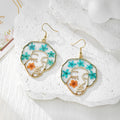 Gold Tone Abstract Face Pressed Flower Drop Earrings in Five Designs view 3