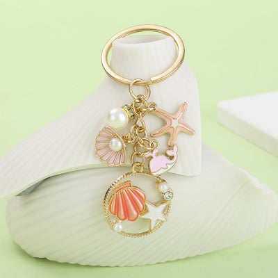 Image 1 showing a key chain with seashells and pearls.