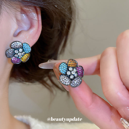 Close view of the colors and surface details on multicolor crystal flower stud earrings