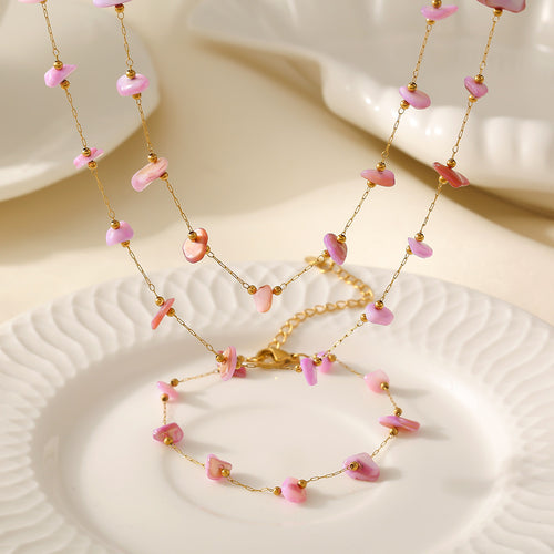 Pink stone chip necklace and bracelet displayed on white plate