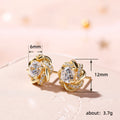 Floral Swirl Clear Stone Stud Earrings In Polished Gold Tone view 4