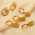Gold Huggie Hoop Earrings with Cowrie Shell Dangle Charms view 2