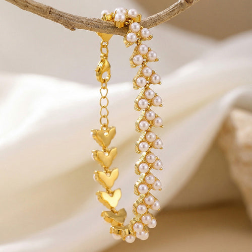 Gold pearl bracelet hanging open showing butterfly reverse