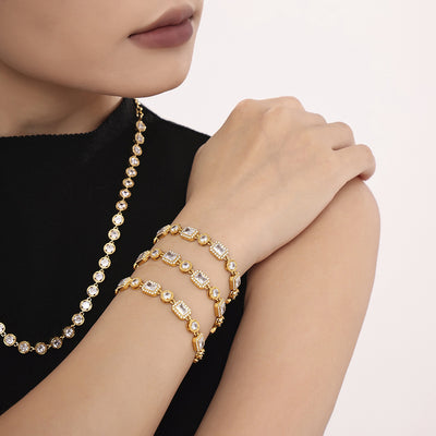 Model wearing stacked gold square-round zircon bracelets with necklace