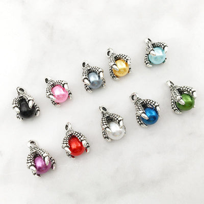 Metallic insect charms arranged on a light background