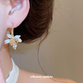 White Floral Hoop Earrings with Gold Tone Leaf Details view 3