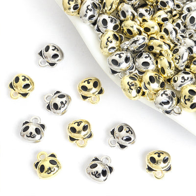 Assorted panda face charms arranged beside a tray