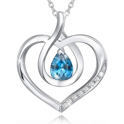 Silver open heart pendant with blue teardrop center on white background