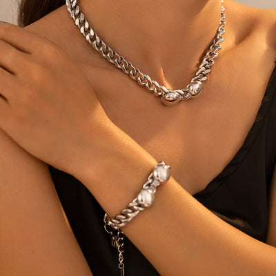 Model wearing silver cuban dual-ball necklace and matching bracelet