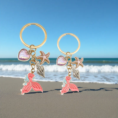 Main display of pink and blue mermaid dolphin shell and starfish keychains