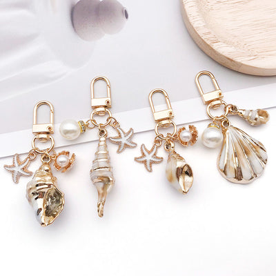Main display of gold tone shell starfish and pearl-look clasp charms