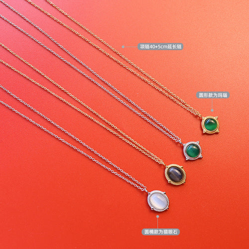 Four agate and cat-eye pendant necklaces flat on red with labels