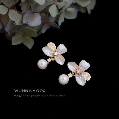 Gold-tone translucent-white-flower pearl-drop studs in the first product display.