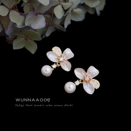 Gold-tone translucent-white-flower pearl-drop studs in the first product display.