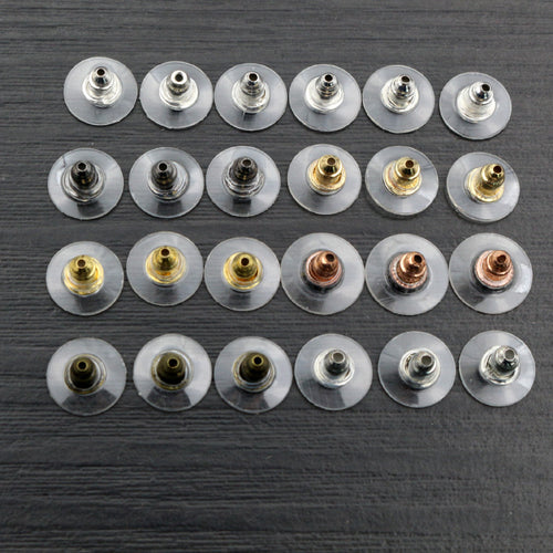 Closer view of clear silicone disc earring backs with metal inserts showing visible finishes and shapes