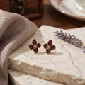 Burgundy Four Petal Flower Gold Tone Stud Earrings view 3