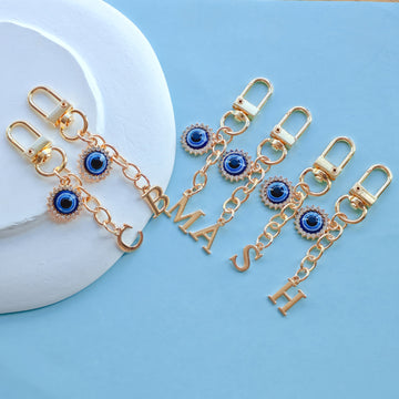 Gold-Tone Rhinestone Evil Eye Charm With Letter Cutout Pendant