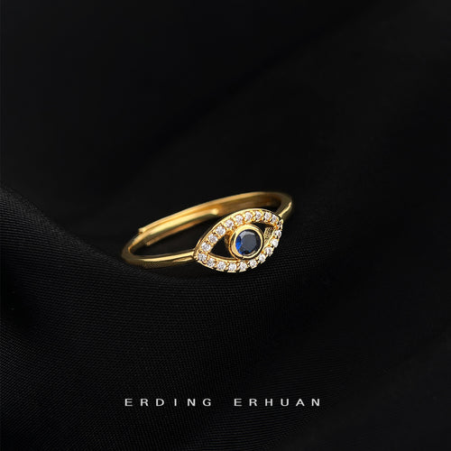 Gold blue crystal eye open ring on black fabric side view