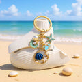 Blue and Pink Shell Dolphin Mermaid and Starfish Keychains view 1