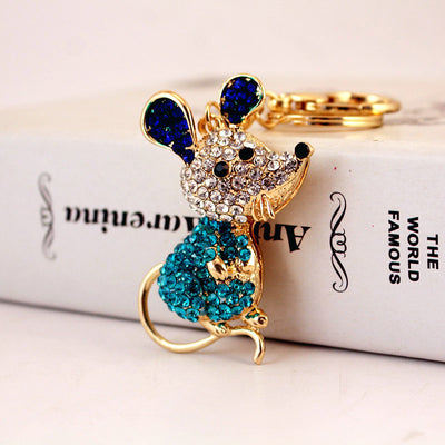 Blue mouse design with turquoise body stones and dark blue ears beside a split key ring.